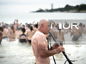 Demonstrators are celebrating their mobilization by swimming in the ocean during a demonstration against the construction of giant water res...