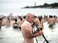 Demonstrators are celebrating their mobilization by swimming in the ocean during a demonstration against the construction of giant water res...