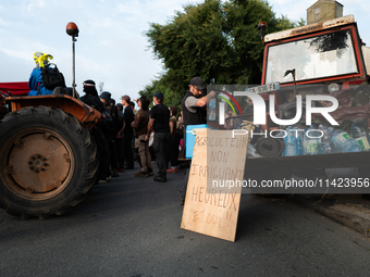 Demonstrators are sitting in front of the Atlantic port of La Rochelle in western France, on July 20, 2024, during a demonstration against t...