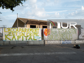 Demonstrators are sitting in front of the Atlantic port of La Rochelle in western France, on July 20, 2024, during a demonstration against t...