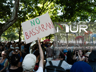 Protesters are holding a pan card saying ''No Bassaran'' during a demonstration against the construction of a giant water reservoir (mega-ba...