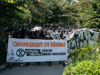 Protesters of Extinction Rebellion are holding a banner that reads ''Change of regime'' during a demonstration against the construction of a...