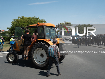 A tractor is near the police during a demonstration against the construction of a giant water reservoir (mega-bassine) in La Rochelle, Franc...