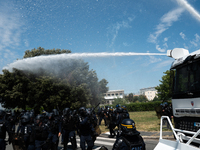 Riot police officers are using a water cannon against demonstrators taking part in a rally against the construction of a giant water reservo...