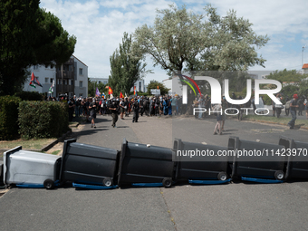 Demonstrators are installing a trash barricade to prevent the advance of the police during a rally against the construction of a giant water...