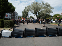 Demonstrators are installing a trash barricade to prevent the advance of the police during a rally against the construction of a giant water...