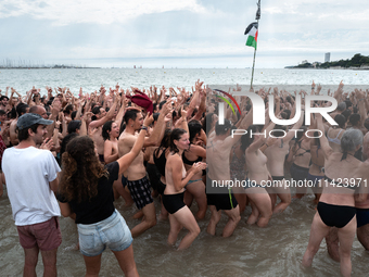 Demonstrators are celebrating their mobilization by swimming in the ocean during a demonstration against the construction of giant water res...