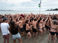 Demonstrators are celebrating their mobilization by swimming in the ocean during a demonstration against the construction of giant water res...