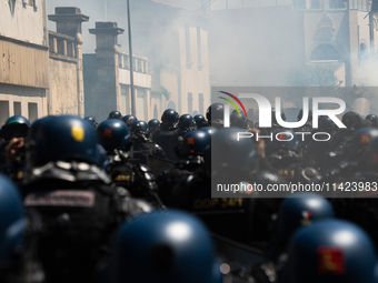 French Gendarmes are wearing riot gear and walking towards the protesters during a rally against the construction of a giant water reservoir...