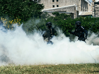 French gendarmes are walking amid the smoke from tear gas during a demonstration against the construction of a giant water reservoir (mega-b...