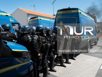 French Gendarmes are wearing riot gear and standing in front of the protesters during a rally against the construction of a giant water rese...