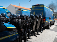 French Gendarmes are wearing riot gear and standing in front of the protesters during a rally against the construction of a giant water rese...