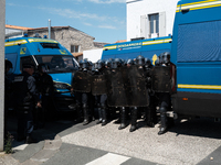 French Gendarmes are wearing riot gear and standing in front of the protesters during a rally against the construction of a giant water rese...