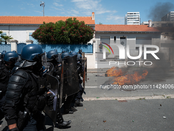 French Gendarmes are wearing riot gear and walking towards the protesters during a rally against the construction of a giant water reservoir...