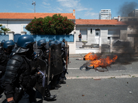 French Gendarmes are wearing riot gear and walking towards the protesters during a rally against the construction of a giant water reservoir...