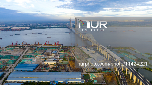 The photo is showing the Chang-Tai Yangtze River Bridge under construction in Taixing, Jiangsu province, China, on July 21, 2024. 