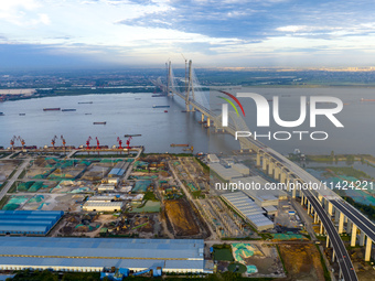 The photo is showing the Chang-Tai Yangtze River Bridge under construction in Taixing, Jiangsu province, China, on July 21, 2024. (