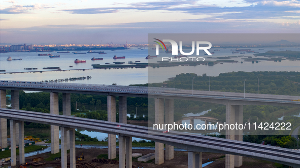 The photo is showing the Chang-Tai Yangtze River Bridge under construction in Taixing, Jiangsu province, China, on July 21, 2024. 