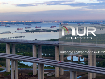 The photo is showing the Chang-Tai Yangtze River Bridge under construction in Taixing, Jiangsu province, China, on July 21, 2024. (