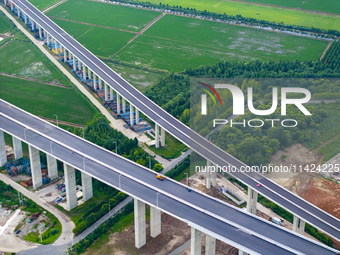 The photo is showing the Chang-Tai Yangtze River Bridge under construction in Taixing, Jiangsu province, China, on July 21, 2024. (