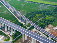 The photo is showing the Chang-Tai Yangtze River Bridge under construction in Taixing, Jiangsu province, China, on July 21, 2024. (