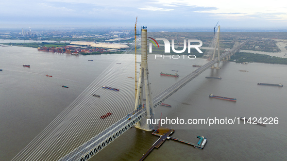 The photo is showing the Chang-Tai Yangtze River Bridge under construction in Taixing, Jiangsu province, China, on July 21, 2024. 