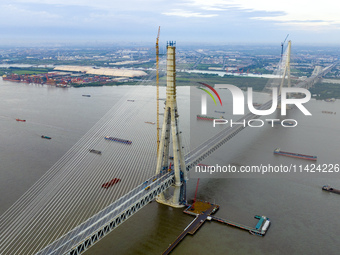 The photo is showing the Chang-Tai Yangtze River Bridge under construction in Taixing, Jiangsu province, China, on July 21, 2024. (