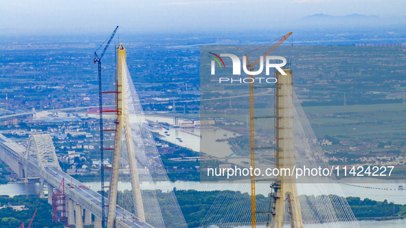 The photo is showing the Chang-Tai Yangtze River Bridge under construction in Taixing, Jiangsu province, China, on July 21, 2024. 