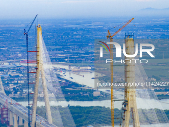 The photo is showing the Chang-Tai Yangtze River Bridge under construction in Taixing, Jiangsu province, China, on July 21, 2024. (