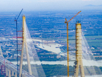 The photo is showing the Chang-Tai Yangtze River Bridge under construction in Taixing, Jiangsu province, China, on July 21, 2024. (