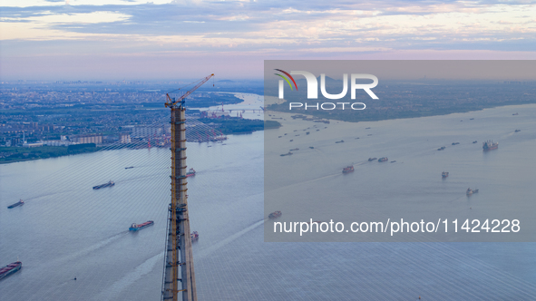 The photo is showing the Chang-Tai Yangtze River Bridge under construction in Taixing, Jiangsu province, China, on July 21, 2024. 