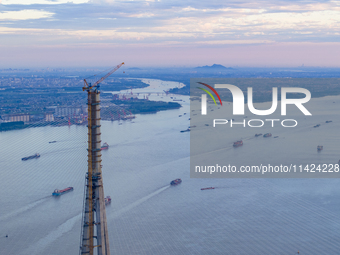 The photo is showing the Chang-Tai Yangtze River Bridge under construction in Taixing, Jiangsu province, China, on July 21, 2024. (