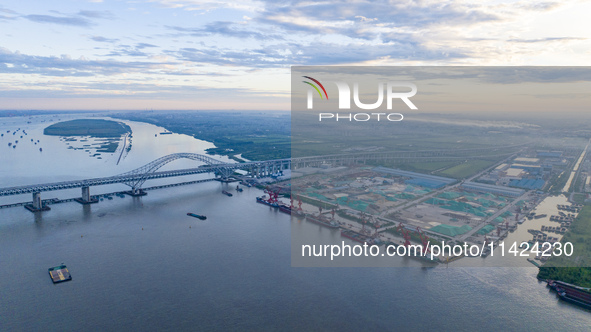 The photo is showing the Chang-Tai Yangtze River Bridge under construction in Taixing, Jiangsu province, China, on July 21, 2024. 