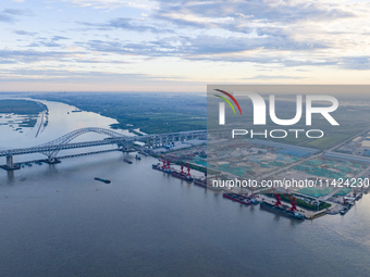 The photo is showing the Chang-Tai Yangtze River Bridge under construction in Taixing, Jiangsu province, China, on July 21, 2024. (