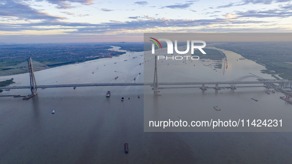 The photo is showing the Chang-Tai Yangtze River Bridge under construction in Taixing, Jiangsu province, China, on July 21, 2024. 