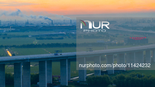 The photo is showing the Chang-Tai Yangtze River Bridge under construction in Taixing, Jiangsu province, China, on July 21, 2024. 