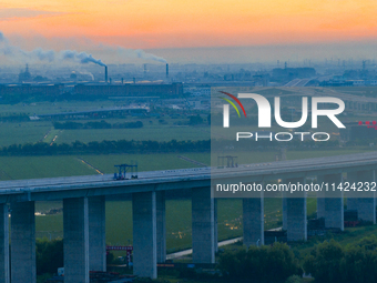 The photo is showing the Chang-Tai Yangtze River Bridge under construction in Taixing, Jiangsu province, China, on July 21, 2024. (