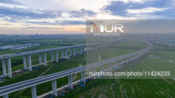 The photo is showing the Chang-Tai Yangtze River Bridge under construction in Taixing, Jiangsu province, China, on July 21, 2024. 