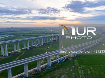 The photo is showing the Chang-Tai Yangtze River Bridge under construction in Taixing, Jiangsu province, China, on July 21, 2024. (