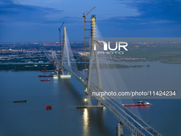 The photo is showing the Chang-Tai Yangtze River Bridge under construction in Taixing, Jiangsu province, China, on July 21, 2024. 