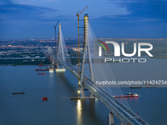 The photo is showing the Chang-Tai Yangtze River Bridge under construction in Taixing, Jiangsu province, China, on July 21, 2024. (