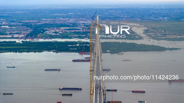 The photo is showing the Chang-Tai Yangtze River Bridge under construction in Taixing, Jiangsu province, China, on July 21, 2024. 