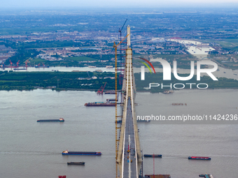 The photo is showing the Chang-Tai Yangtze River Bridge under construction in Taixing, Jiangsu province, China, on July 21, 2024. (