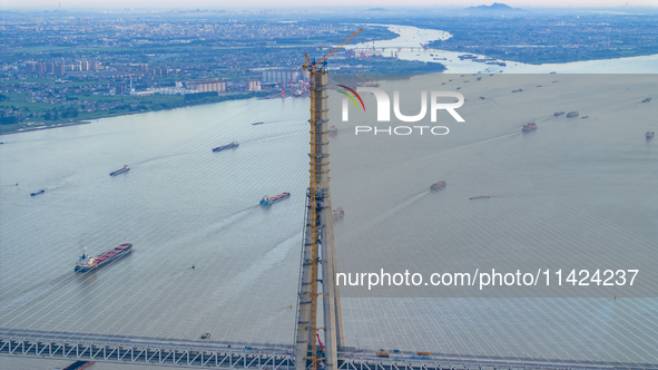 The photo is showing the Chang-Tai Yangtze River Bridge under construction in Taixing, Jiangsu province, China, on July 21, 2024. 