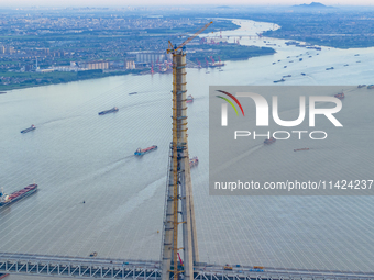 The photo is showing the Chang-Tai Yangtze River Bridge under construction in Taixing, Jiangsu province, China, on July 21, 2024. (