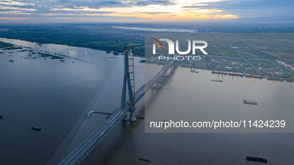 The photo is showing the Chang-Tai Yangtze River Bridge under construction in Taixing, Jiangsu province, China, on July 21, 2024. 