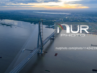 The photo is showing the Chang-Tai Yangtze River Bridge under construction in Taixing, Jiangsu province, China, on July 21, 2024. (