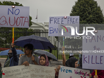 Demonstrators of the Bangladeshi community are displaying signs with the words ''No Quota, Free Free Bangladesh, Hang the Killer'' among oth...