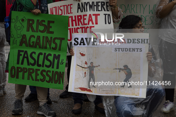 Demonstrators of the Bangladeshi community are displaying signs with the words ''Rise Against Fascism & Oppression, Save Bangladeshi Student...