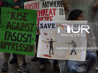 Demonstrators of the Bangladeshi community are displaying signs with the words ''Rise Against Fascism & Oppression, Save Bangladeshi Student...